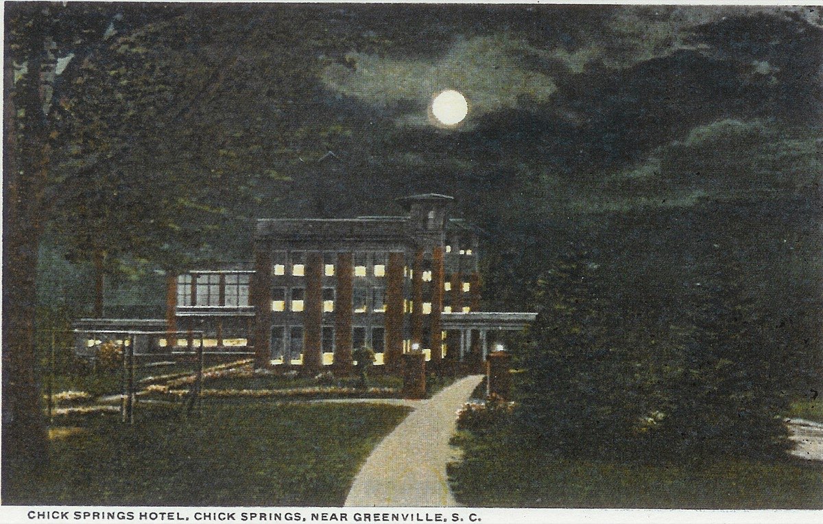 The Chick Springs Hotel illuminated at night by electric lights, c. 1914–1920